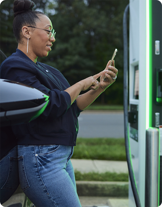Woman using a charging station and looking at her phone