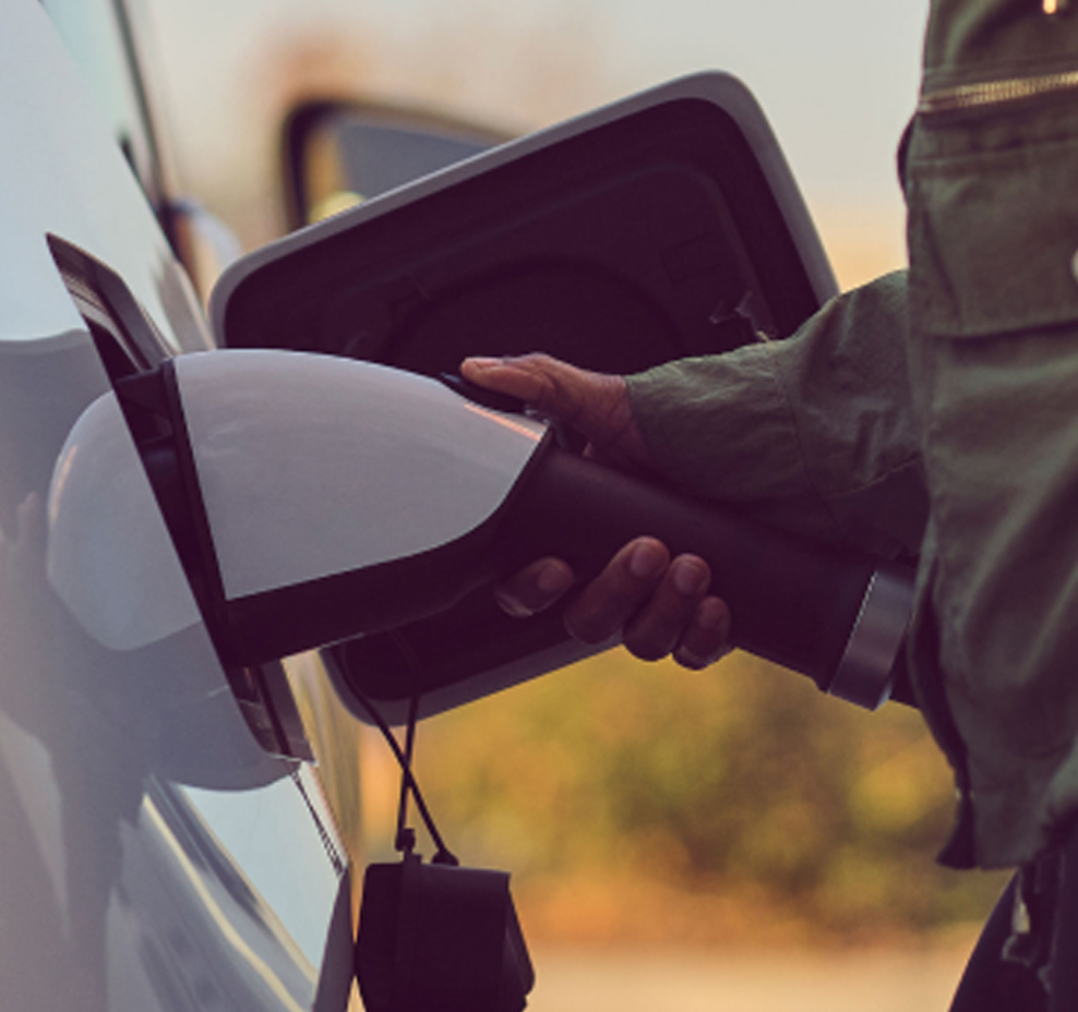 Closeup of a person fueling an electric vehicle.