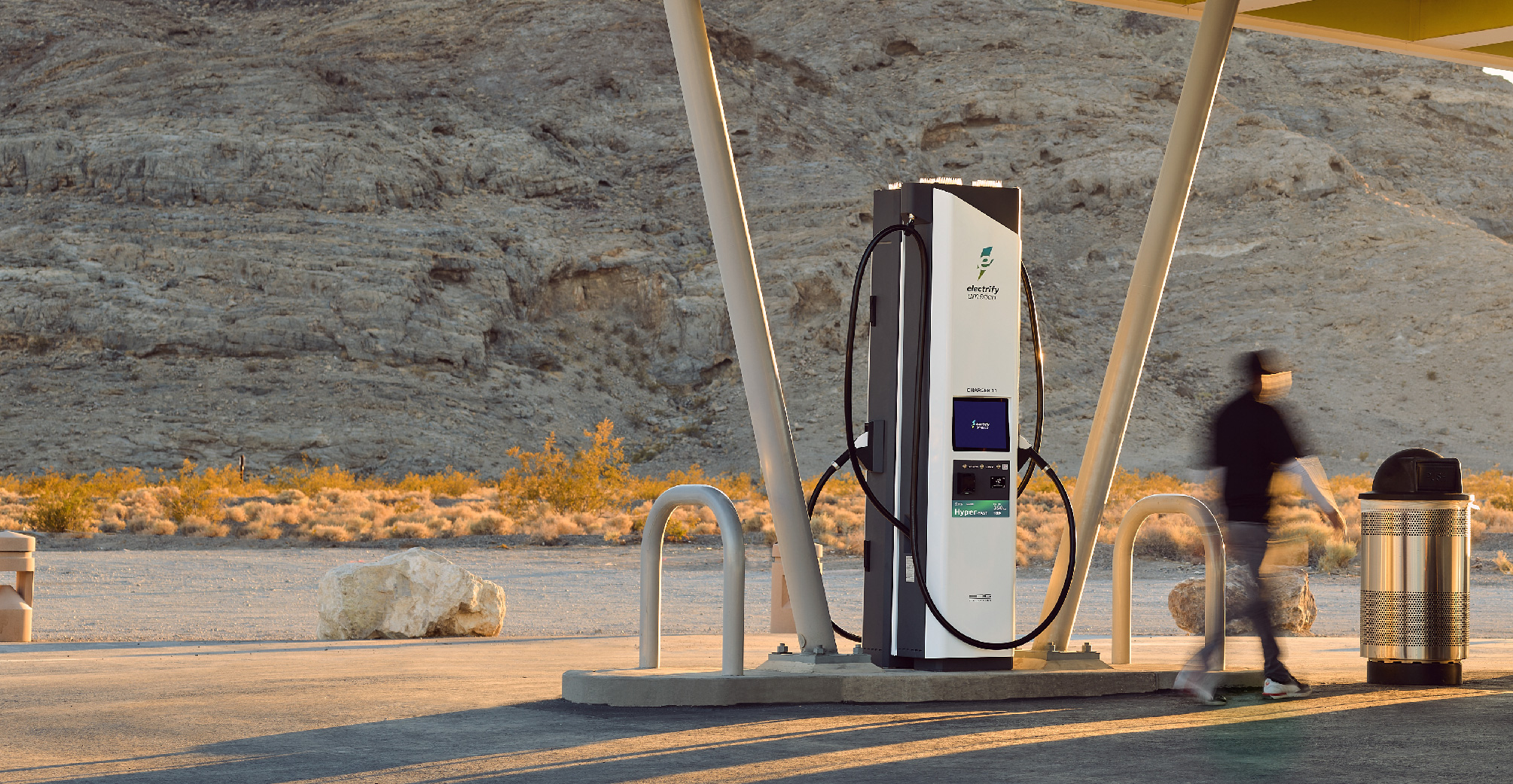 This image displays an Electrify America charging station in the desert